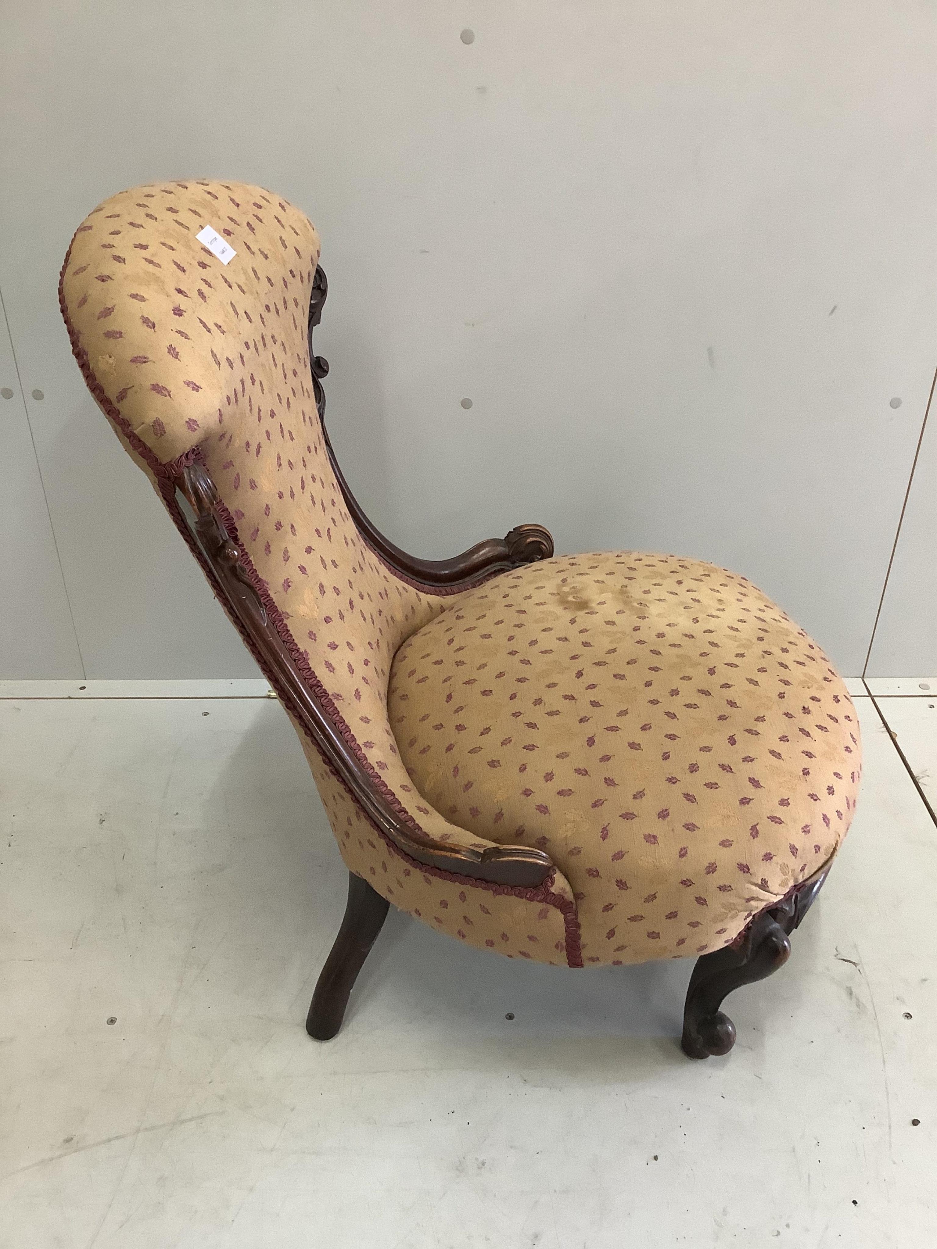 A Victorian mahogany nursing chair, width 58cm, depth 54cm, height 82cm. Condition - fair